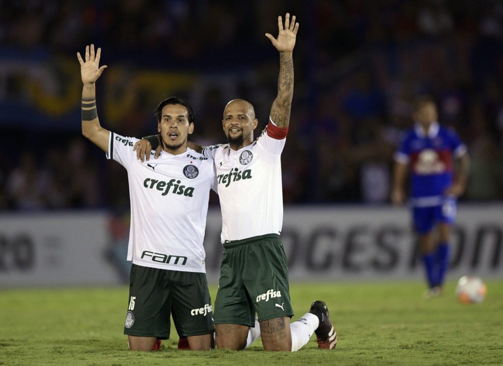 Brazil's Palmeiras defender Gustavo Gomez (L) and midfielder Felipe Melo (C) celebrate the second team's goal during their Copa Libertadores football match, at the Monumental Victoria stadium in Victoria, Buenos Aires Province, on March 4, 2020. (Photo by JUAN MABROMATA / AFP) (Photo by JUAN MABROMATA/AFP via Getty Images)