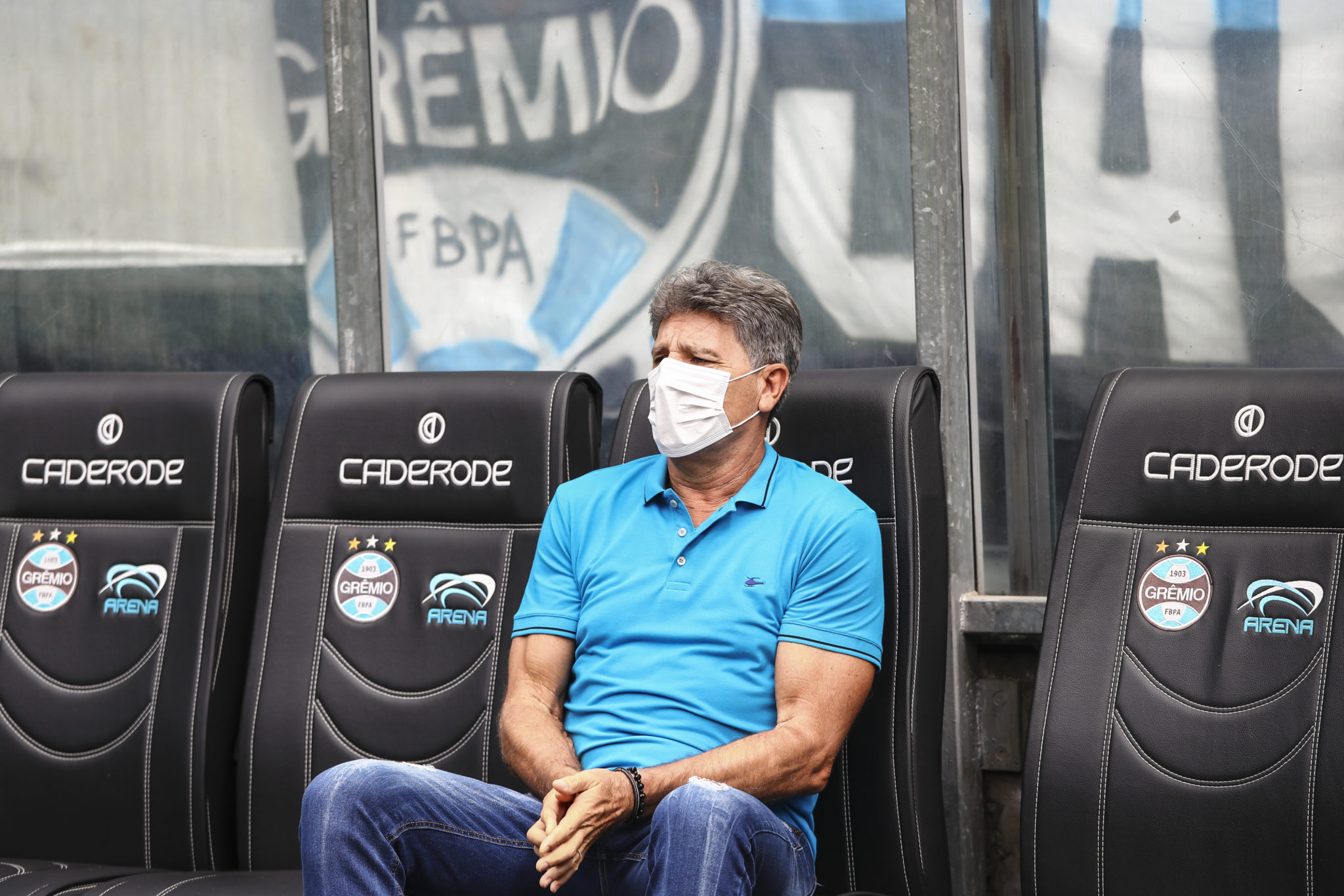 PORTO ALEGRE, BRAZIL - MARCH 15: Renato Portaluppi coach of Gremio enter the field wearing masks before the match between Gremio and Sao Luiz as part of the Rio Grande do Sul State Championship 2020, to be played behind closed doors at Arena do Gremio Stadium, on March 15, 2020 in Porto Alegre, Brazil. The Government of the State of Rio Grande do Sul issued a list of new guidelines to help prevent the spread of the Coronavirus which included games played with closed doors and no public. According to the Ministry of Health, as of Saturday, March 14, Brazil had 121 confirmed cases of coronavirus. (Photo by Lucas Uebel/Getty Images)